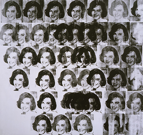 A screenprint of a person's face in black many times over a silver canvas.