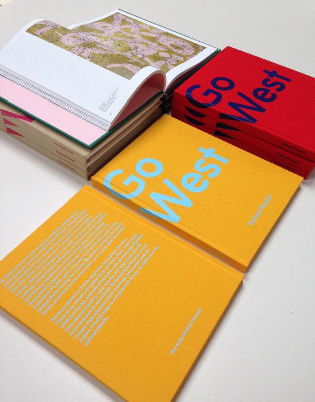 Stack of Go West catalogs in various color schemes