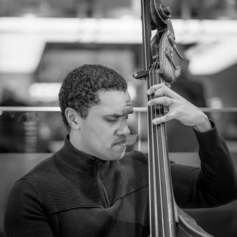 Man in deep concentration plays an upright bass.