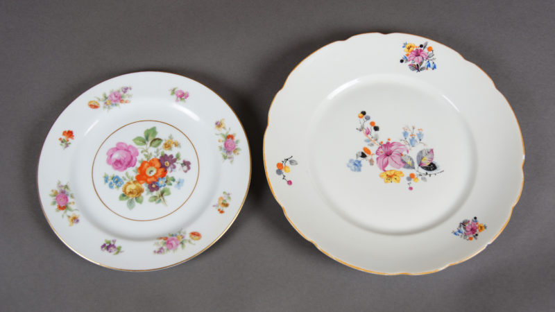 Front view of two porcelain dishes of different sizes. Each dish features variant floral designs.