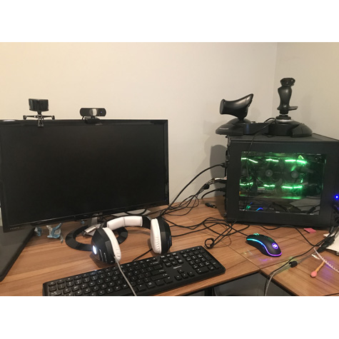 Computers, keyboards, and headphones on a table