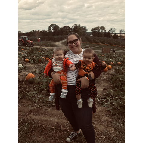 Photo of a woman holding two small children